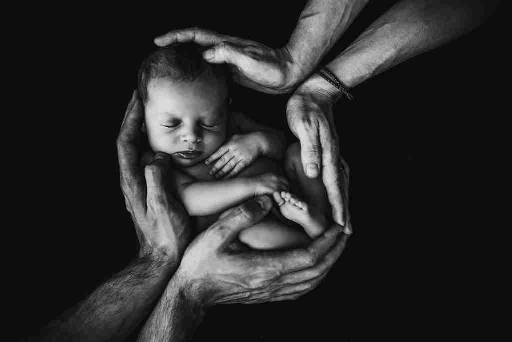 parents holding their son, like Leah's sons