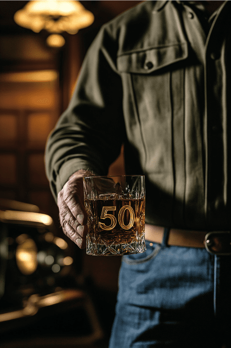 a guy holding a glass of whisky for his birthday