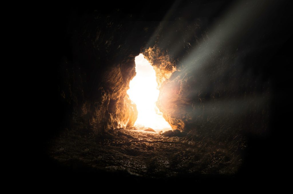 light shining at the end of the gave showing the hope and new life that jesus brought when he did come to earth