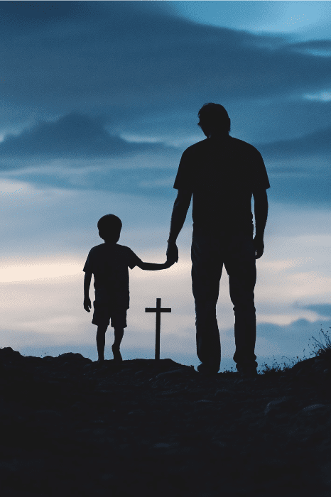 Silhueta de um adulto e uma criança de mãos dadas, caminhando em direção a uma cruz contra um céu de pôr do sol - capturando a essência de momentos queridos, como cenas de poemas sinceros do Dia dos Pais.