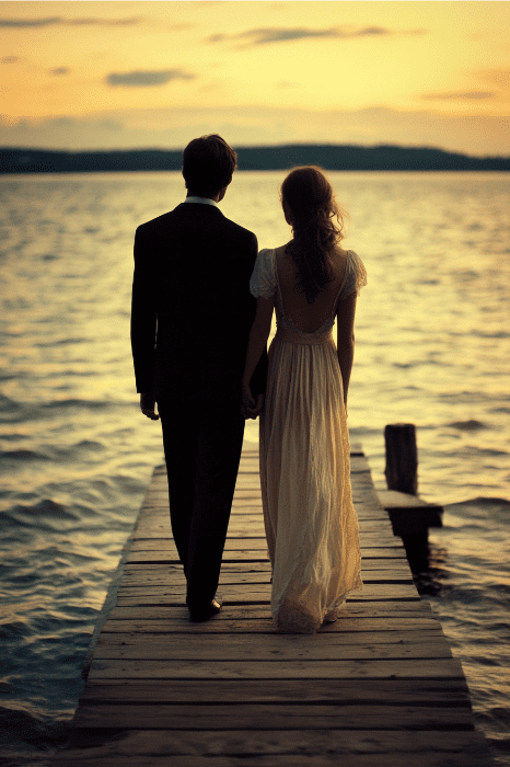 Una pareja, que recuerda al hombre y la mujer de la Biblia, está de pie en un muelle, cogidos de la mano, mientras contemplan una puesta de sol sobre el tranquilo lago.