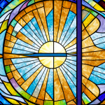 A church with a sunbeam shining through a stained glass window