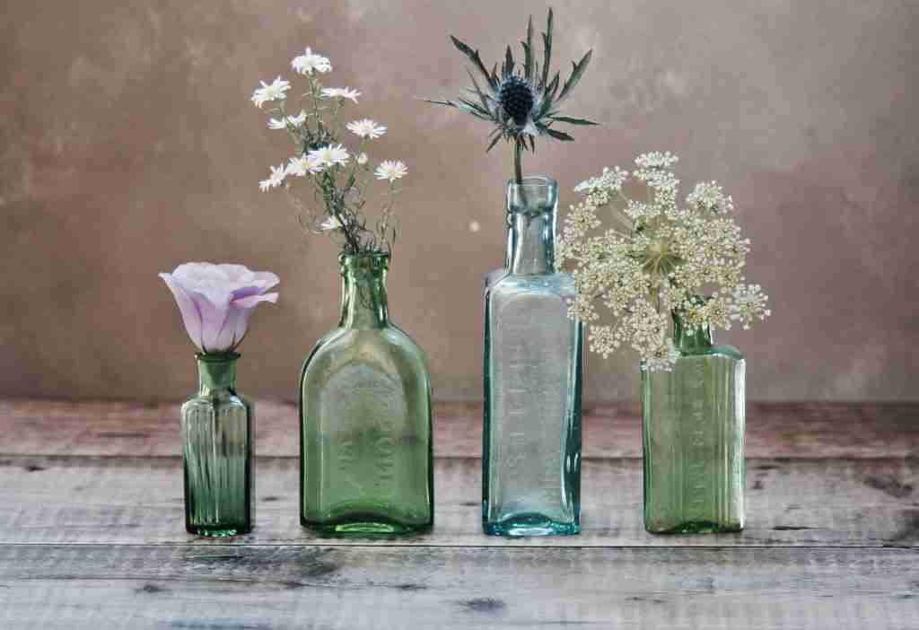 empty bottles with flowers in them - AA hope symbol