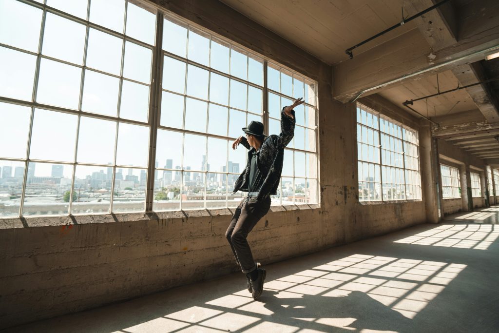 A man dances freestyle in front of a large window to constrast with dance in the Bible and bring it into today's Christian expression of dance
