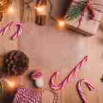 5 Christmas Sunday School Lessons: Free Advent Kits The festive table is set with candy canes, dried oranges, pinecones, fairy lights, and wrapped gifts—perfect for a Christmas Sunday School lesson atmosphere.