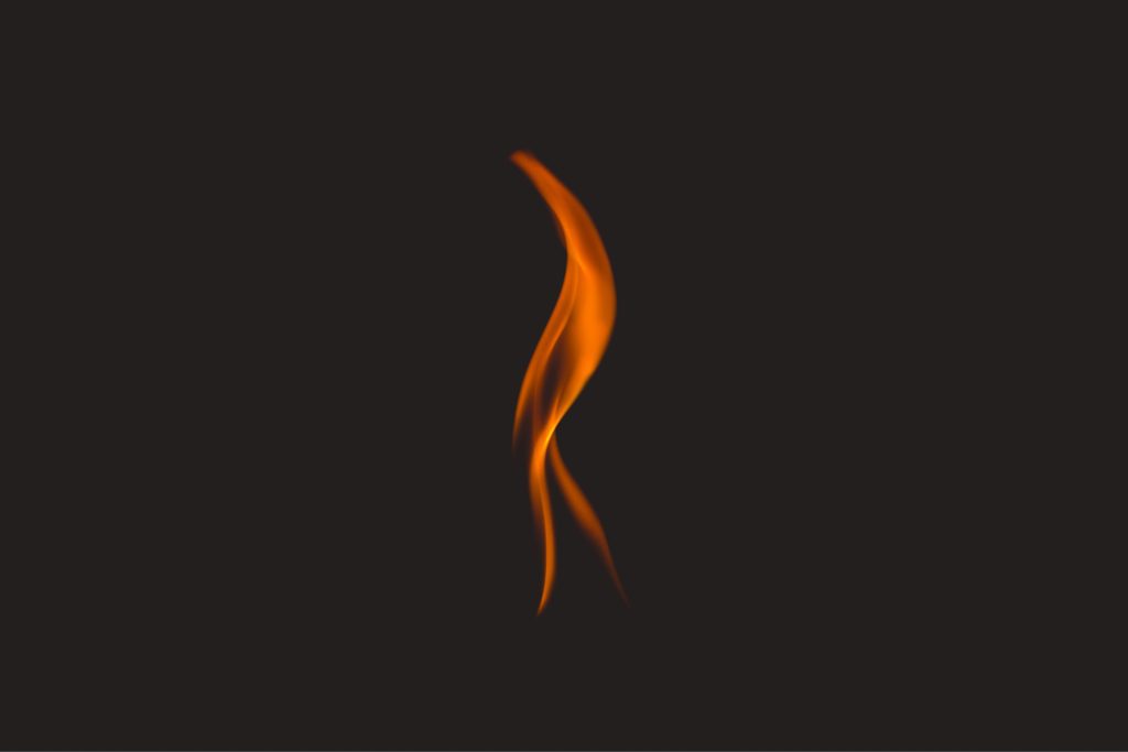 A single flame in front of a black background, showing fire in the Bible