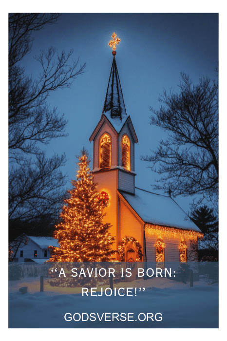 Uma igreja com neve adornada com luzes de Natal e uma árvore iluminada apresenta a mensagem: "A Savior is Born: Rejoice!" e "GODSVERSE.ORG". Esse é um exemplo perfeito de dizeres de placas de igreja para o Natal.