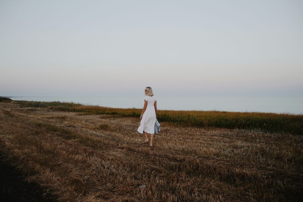 Woman walking in a field, like heartbroken Leah from the Bible