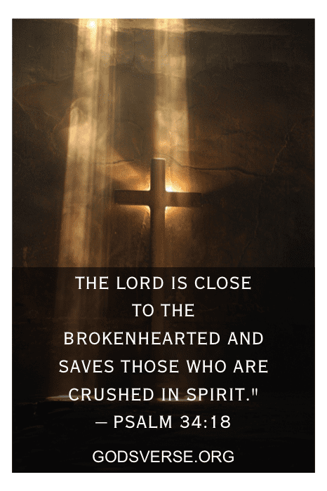 Uma cruz iluminada por raios de luz com o versículo bíblico Salmo 34:18, refletindo um dos muitos versículos bíblicos sobre a bondade de Deus, e o site godsverse.org escrito abaixo.