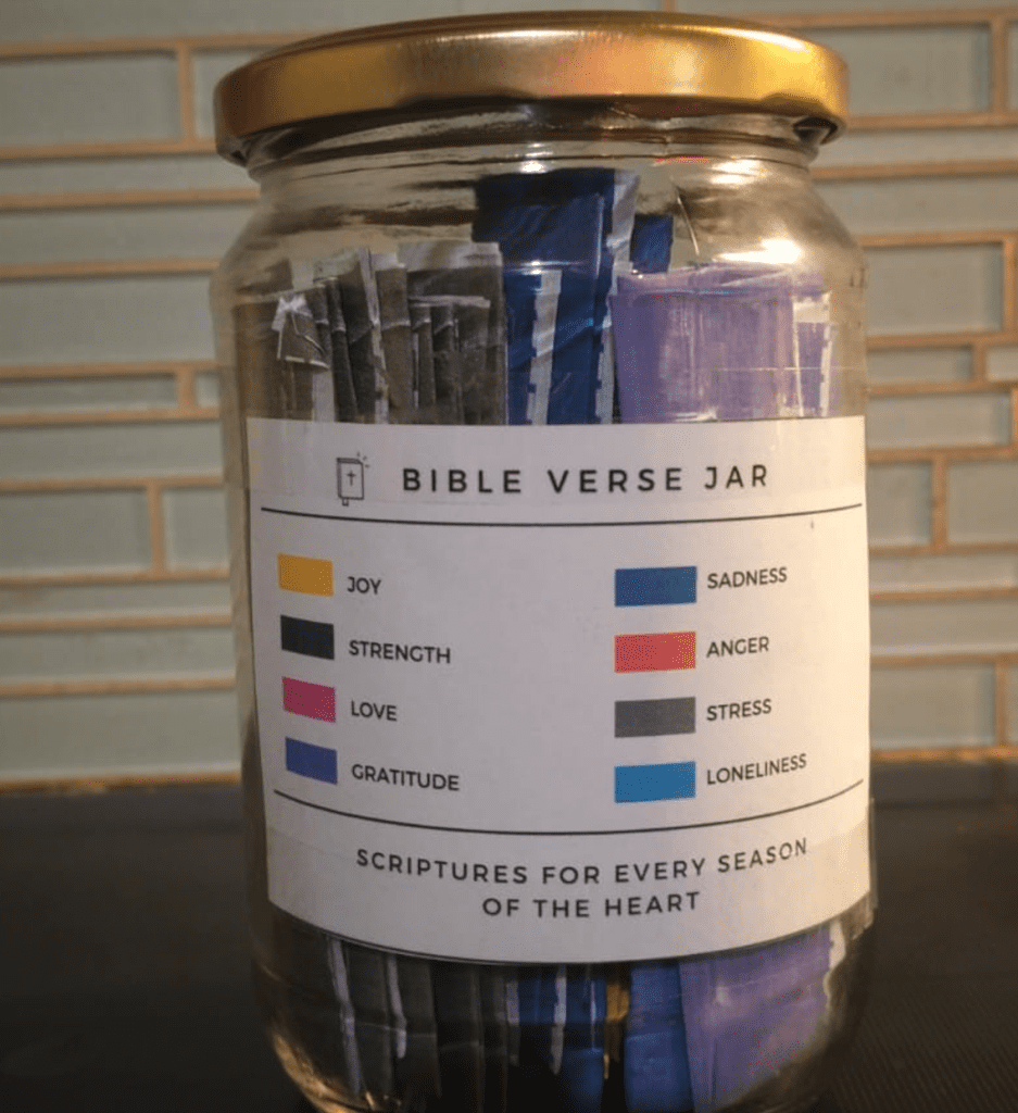 A jar labeled "Bible Verse Jar" contains color-coded slips for various emotions like joy, strength, and sadness.