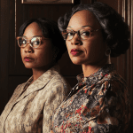 10 Best Black History Church Skits: Downloadable Scripts Two women in vintage attire and glasses stand near a sign about change and empowerment.