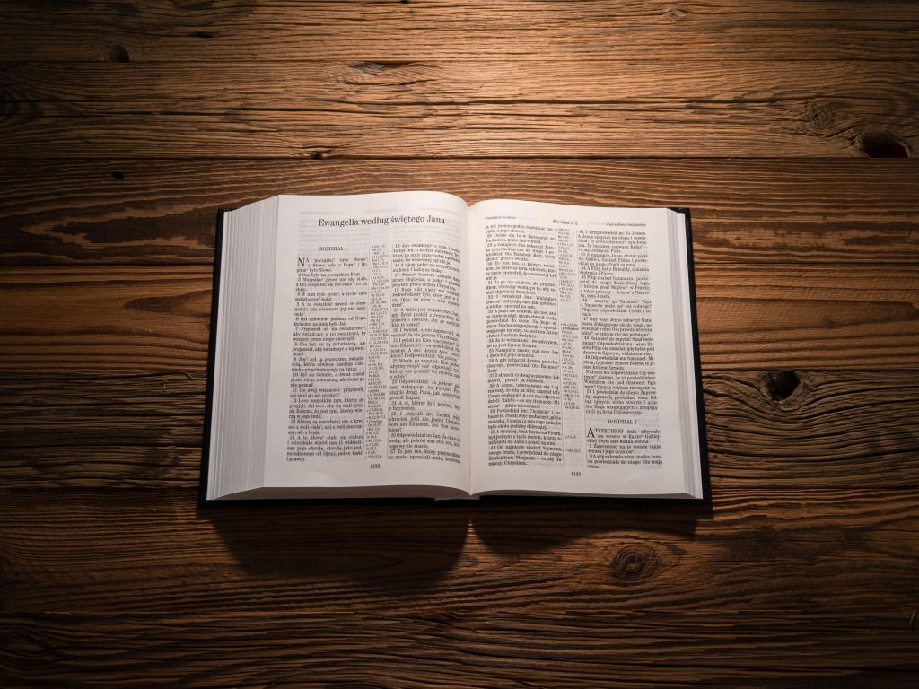An open Bible lying on a wooden table
