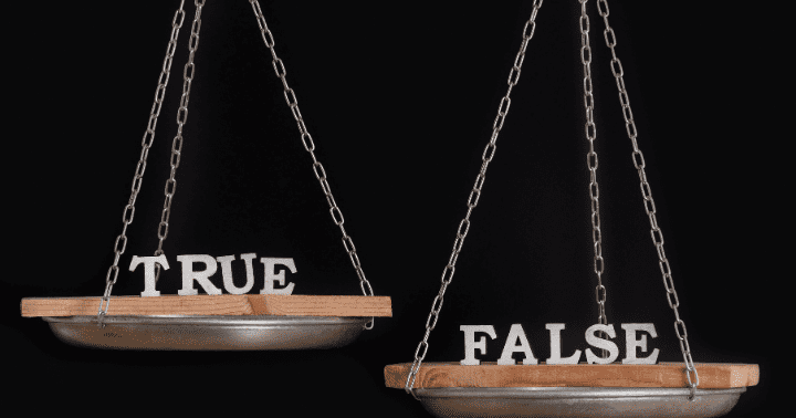 A balance scale with "TRUE" on one side and "FALSE" on the other, set against a black background.